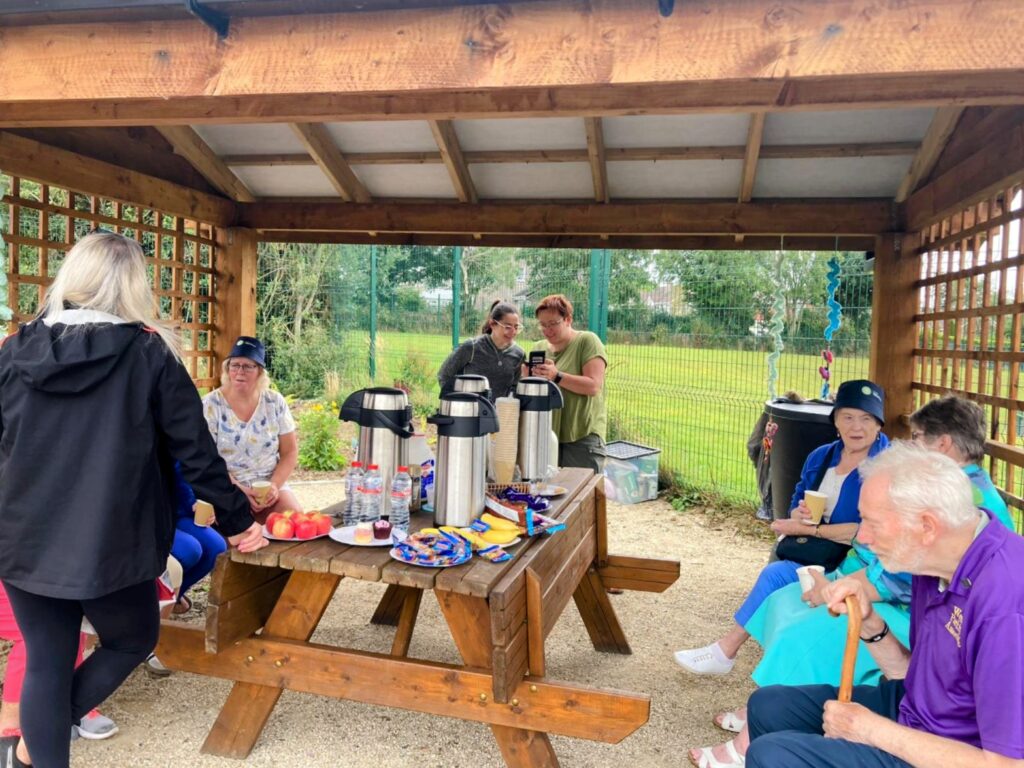 Visitors enjoying some tea and biscuits under our gazebo 