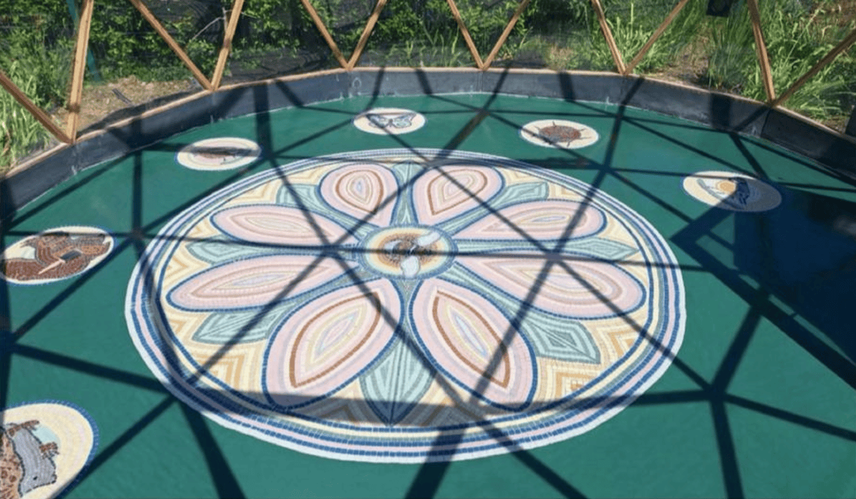 Geosphere Mosaic floor with flower and wildlife designs inside geodesic dome at Enniscorthy Community Allotments.